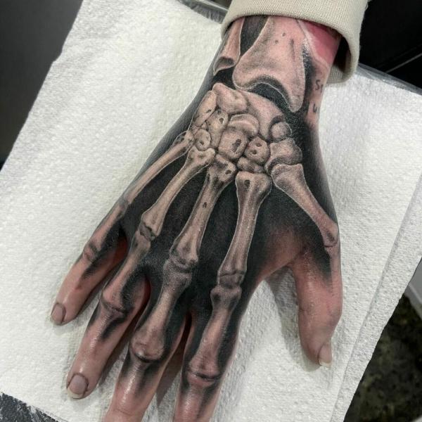 60 Skeleton Hand Tattoo Ideas with Meaning