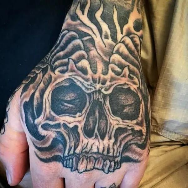 50 Skull Hand Tattoo Designs with Meaning