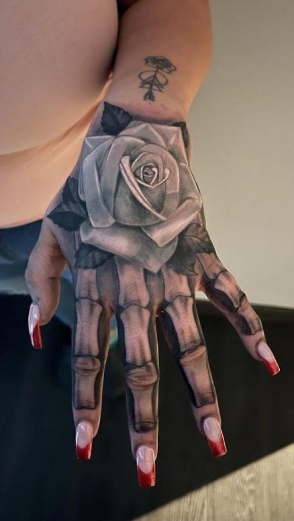50 Skull Hand Tattoo Designs with Meaning