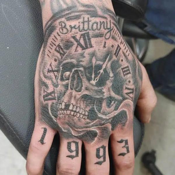 50 Skull Hand Tattoo Designs with Meaning