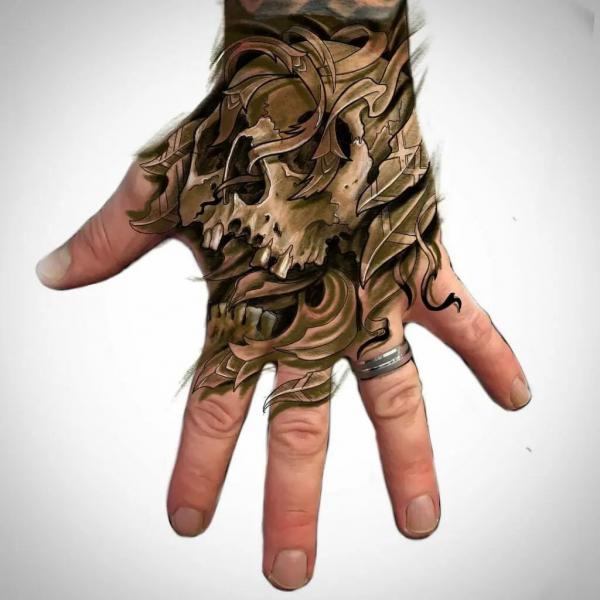 50 Skull Hand Tattoo Designs with Meaning